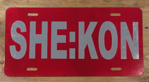 License Plate: Red with SHE:KON