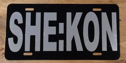 License Plate: Black with SHE:KON